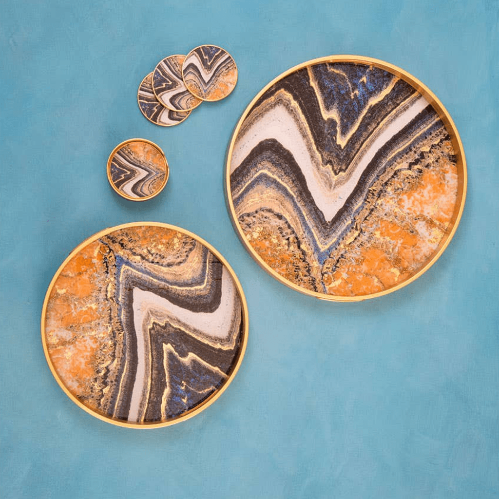 Set of decorative plates with marbled design on a blue background