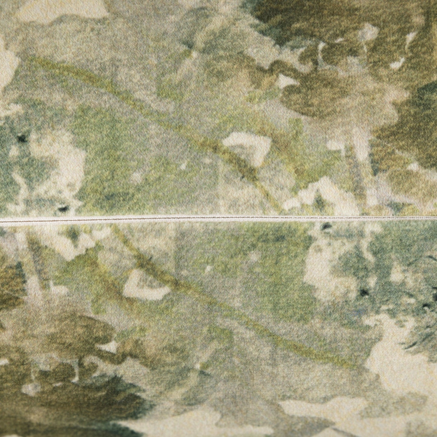 Close-up of a textured green surface with a zip