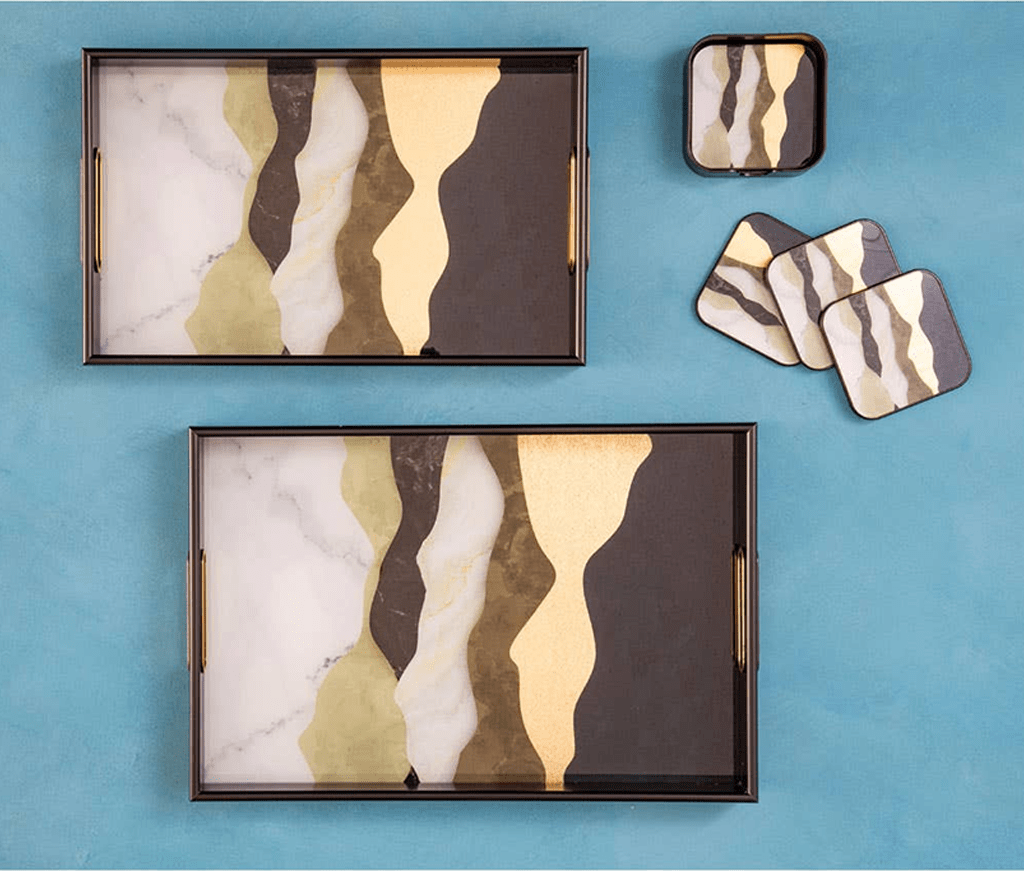 Decorative trays and coasters with abstract design on a blue background