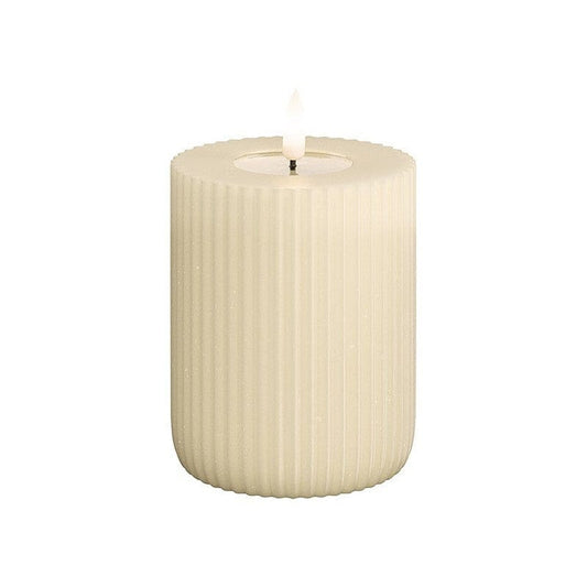 A cream-colored solid stripe LED candle, with a textured surface, designed to create a warm and cozy ambiance.