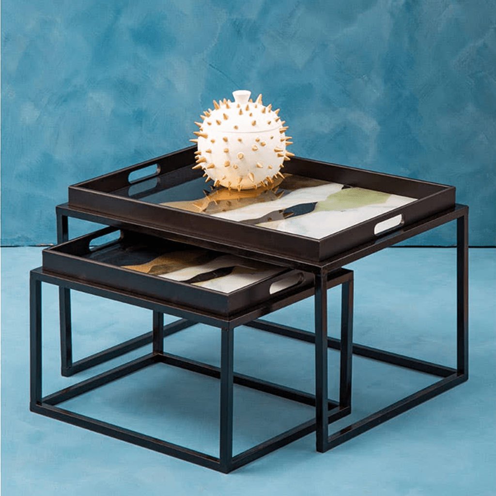 Nesting trays with decorative item on a blue background
