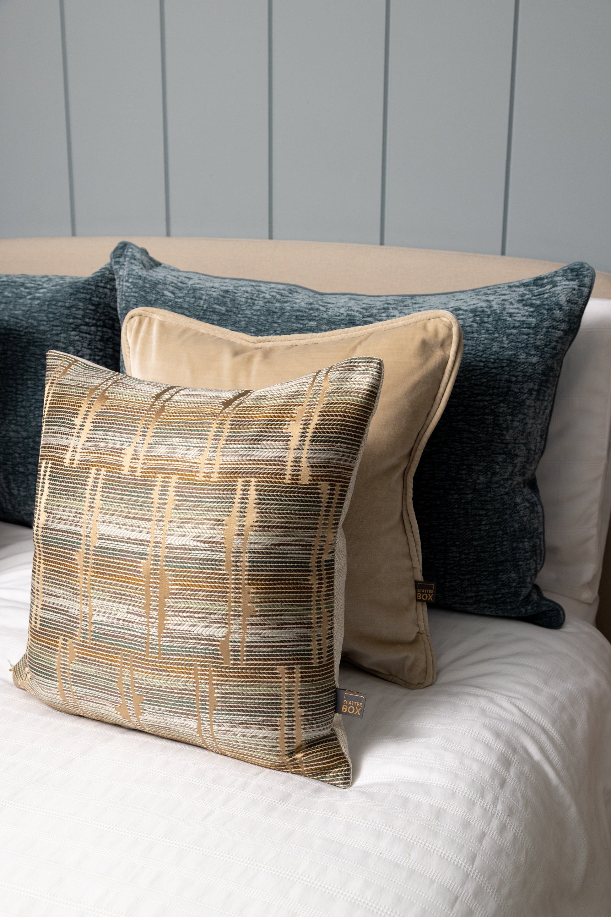 Decorative pillows on a bed with a neutral color scheme
