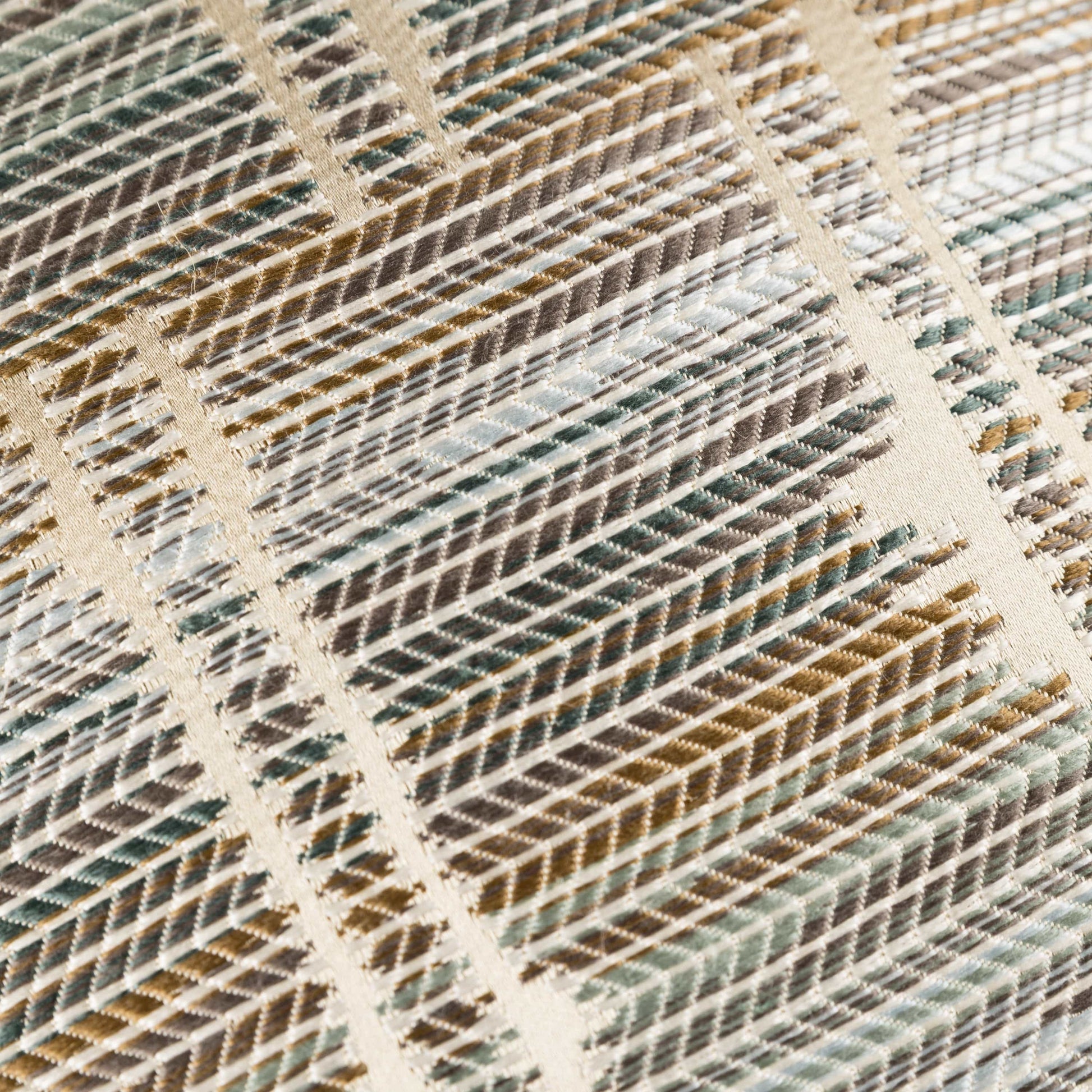 Close-up of a textured fabric with a geometric pattern in earthy tones.