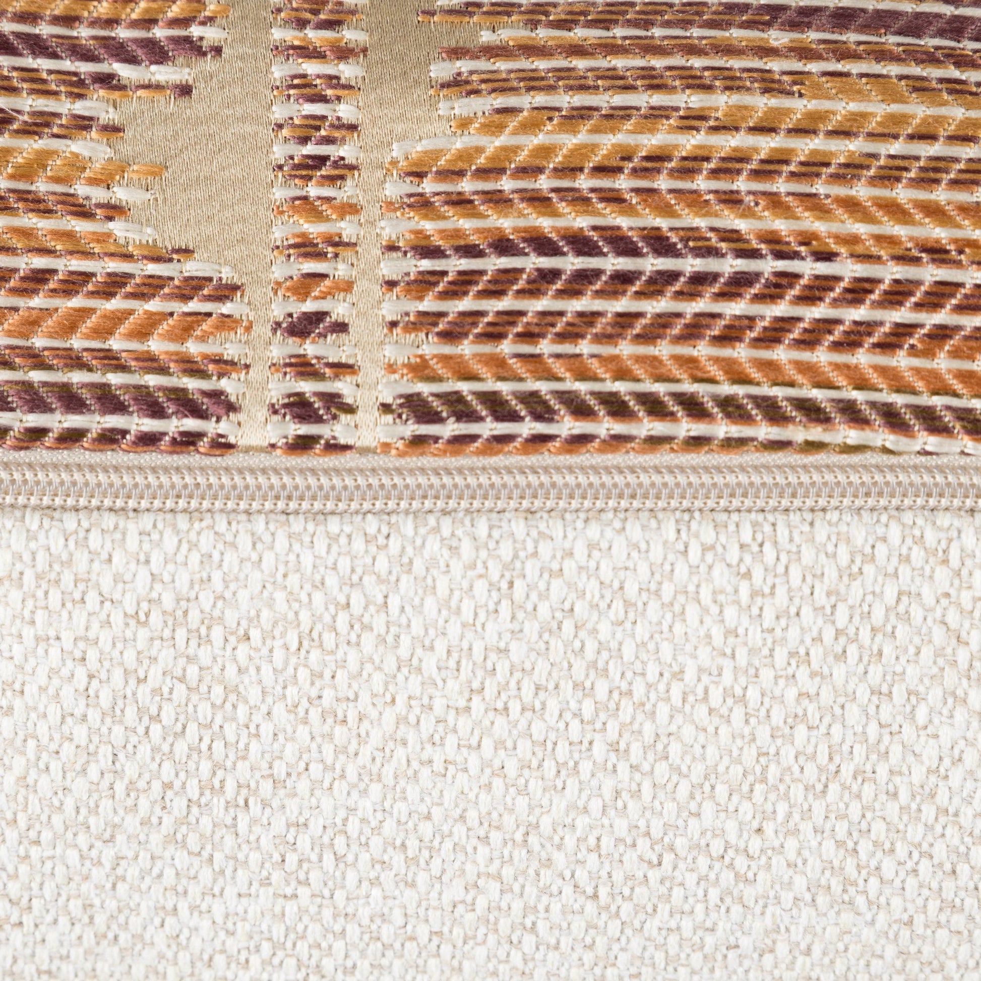 Close-up of a textured fabric with a patterned top section and plain bottom section.
