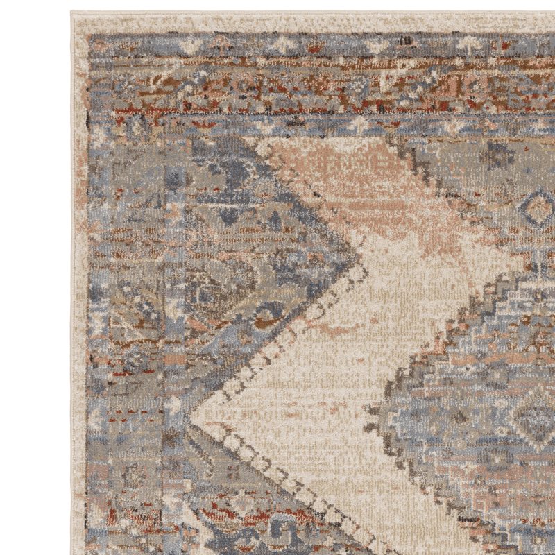 A persian style rug on a white background made up of blues, beiges and red accents