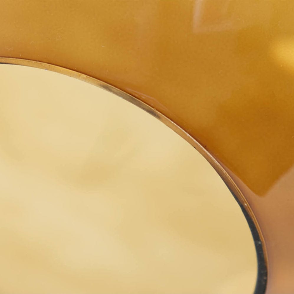 Close-up of a yellow chair with a black rim on a white background