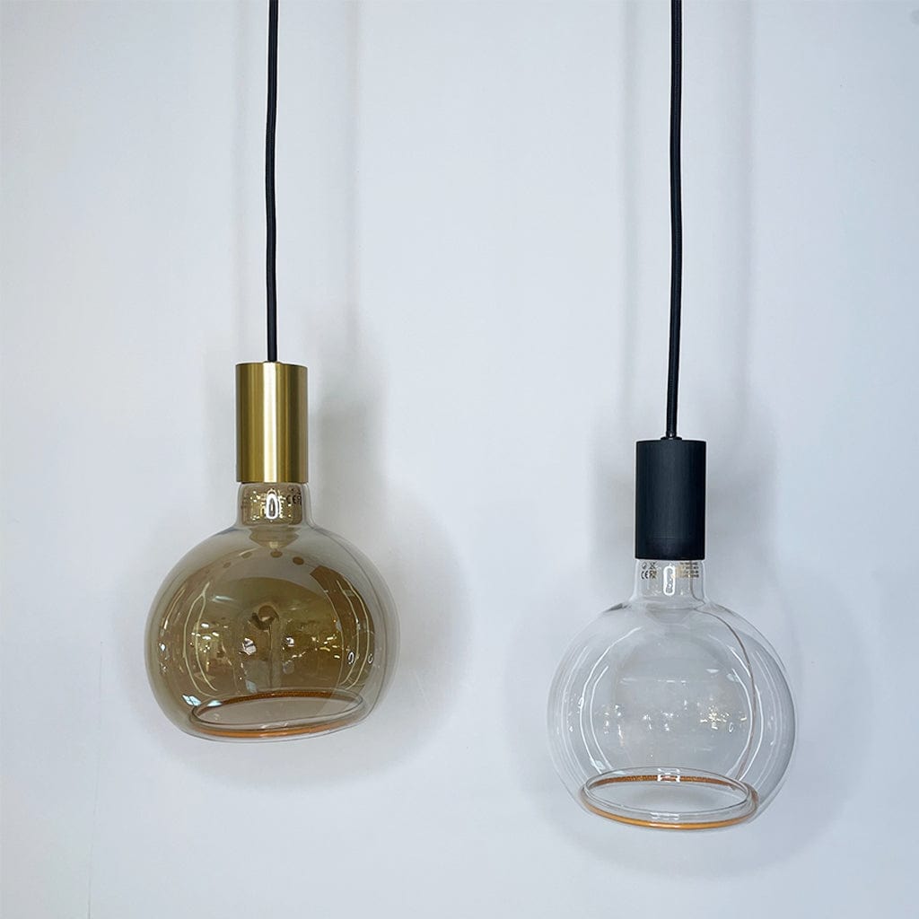Two pendant lights with glass shades and metal bases on a white background