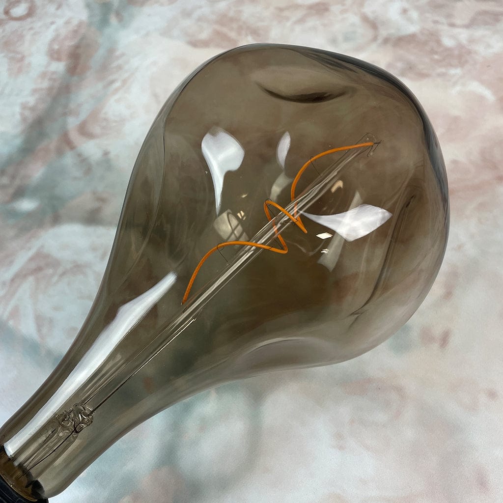 a close up of An E27 Organic XXL Natural LED Bulb with a smoked glass enclosure and visible filament inside.