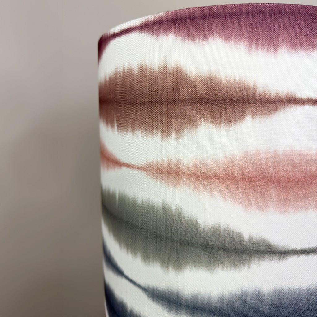 Close-up of a fabric with multicolored stripes on a neutral background