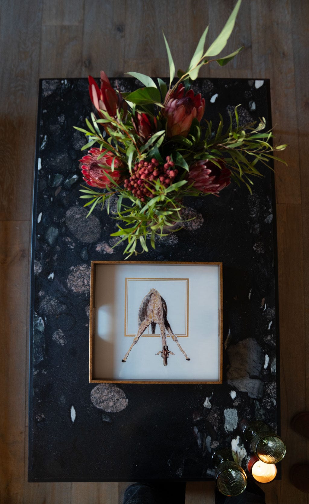 Decorative table with floral arrangement and square giraffe tray