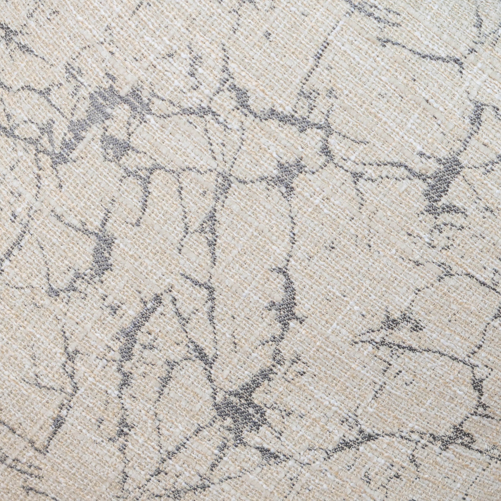 Close-up of a textured fabric with a subtle pattern on a neutral background