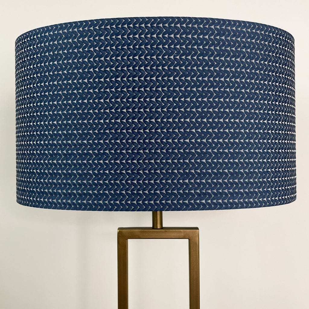 Lamp with a blue textured shade on a white background
