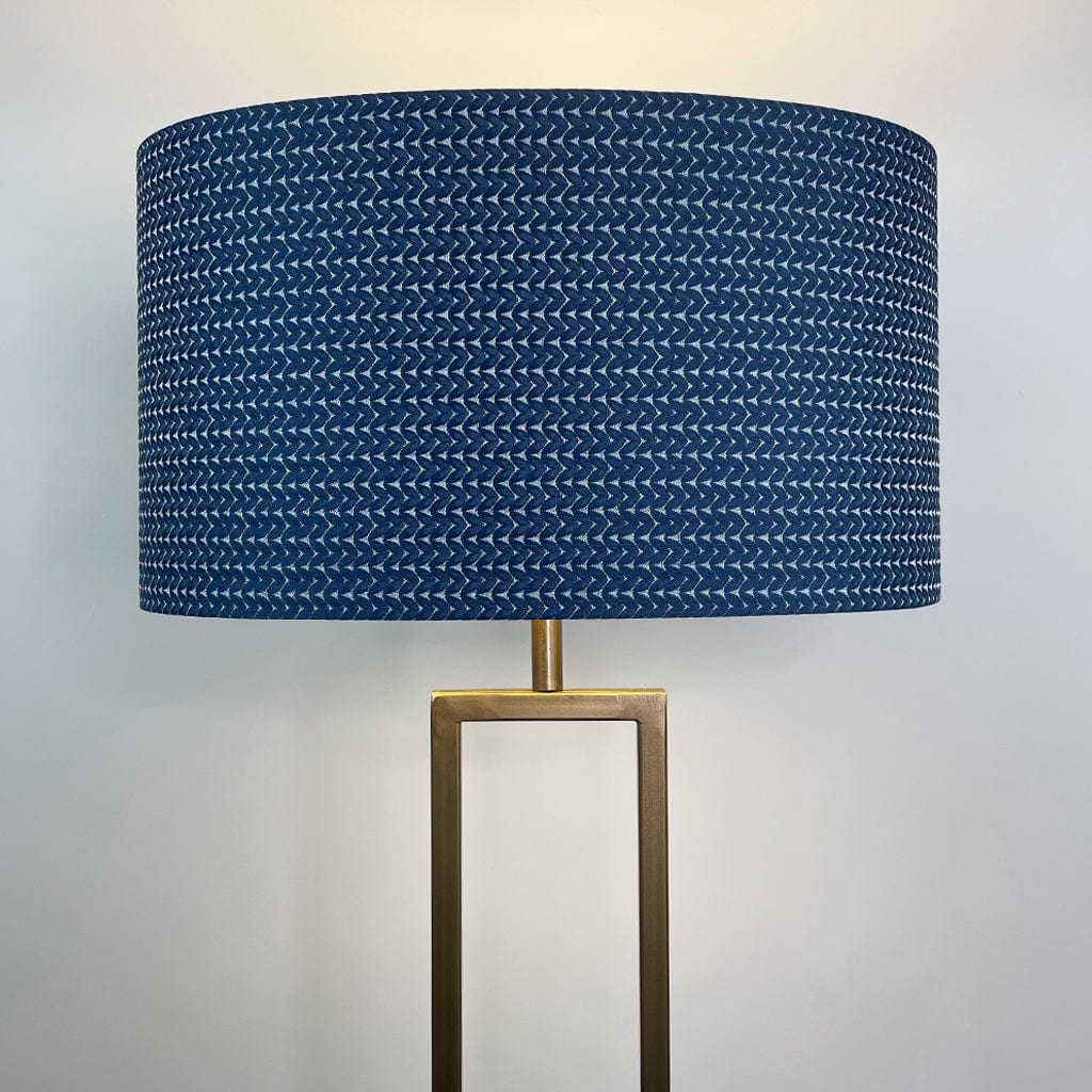 Lamp with a blue patterned shade on a white background