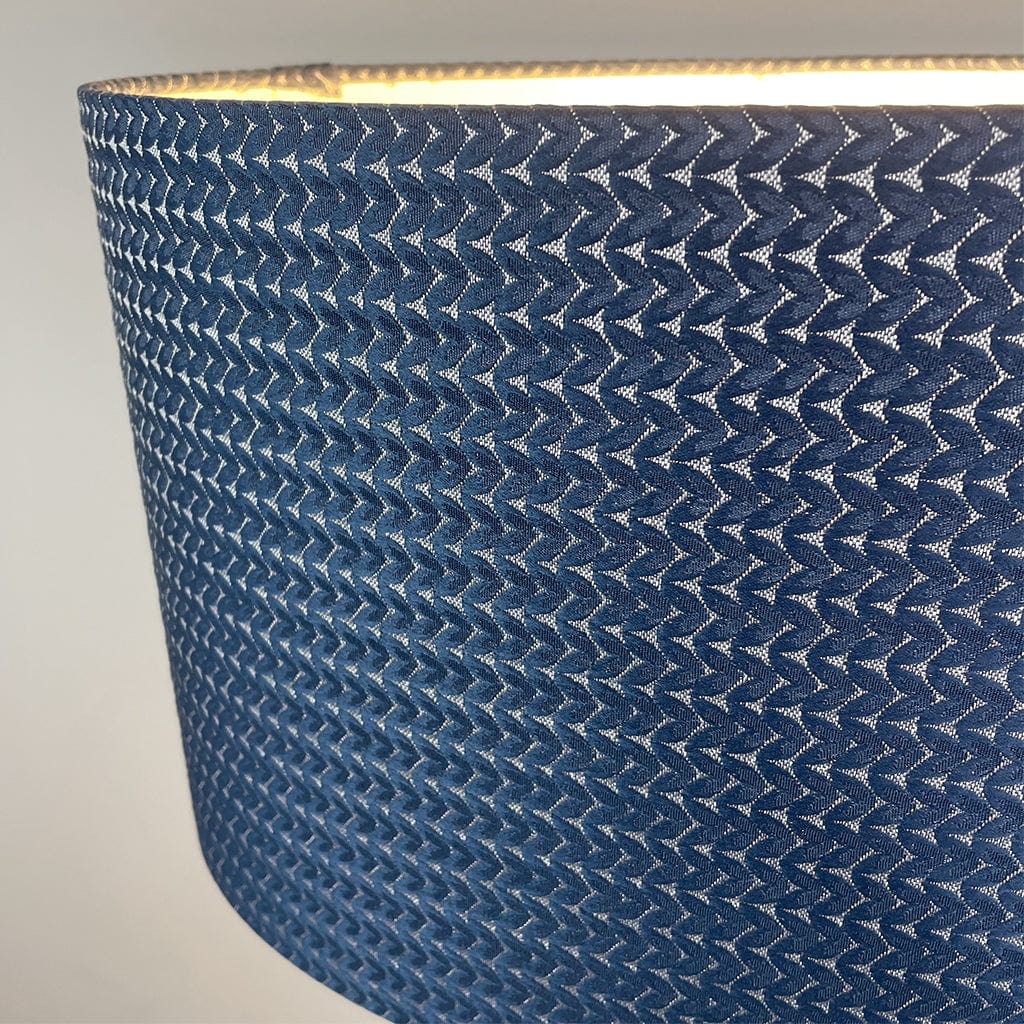 Close-up of a blue textured lampshade on a neutral background