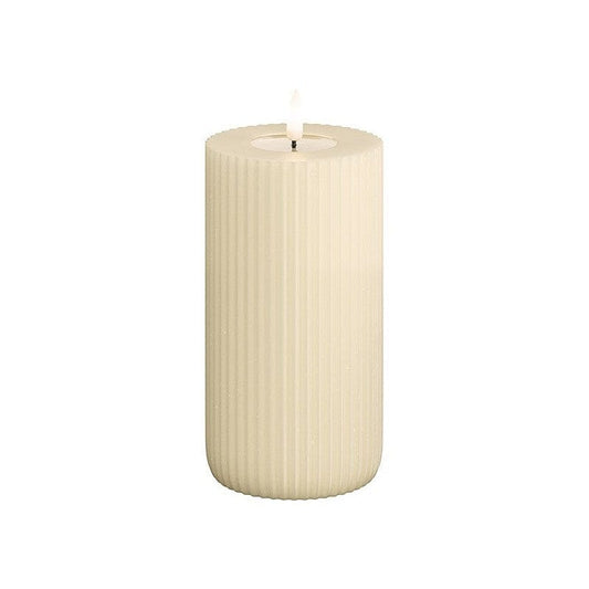 A cylindrical cream-colored LED candle with solid stripes, emitting a warm light.