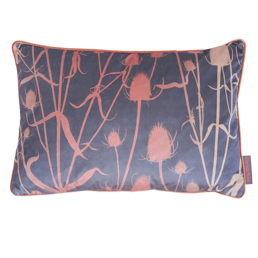 A rectangular cushion with a floral pattern featuring teasel in pink and stone colors on a dark background with orange piping.
