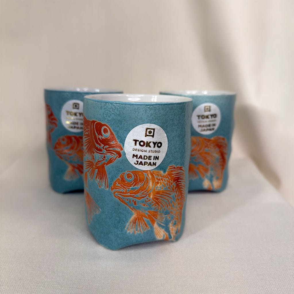 Three ceramic cups with goldfish design and 'Tokyo Design Studio Made in Japan' label on a white background.
