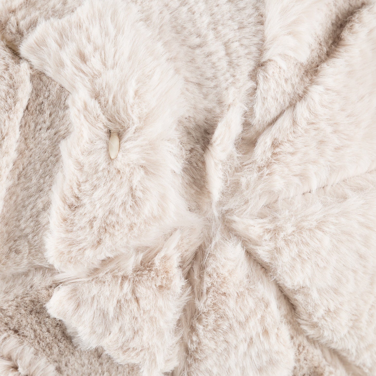 Close up of a natural beige fluffy cushion