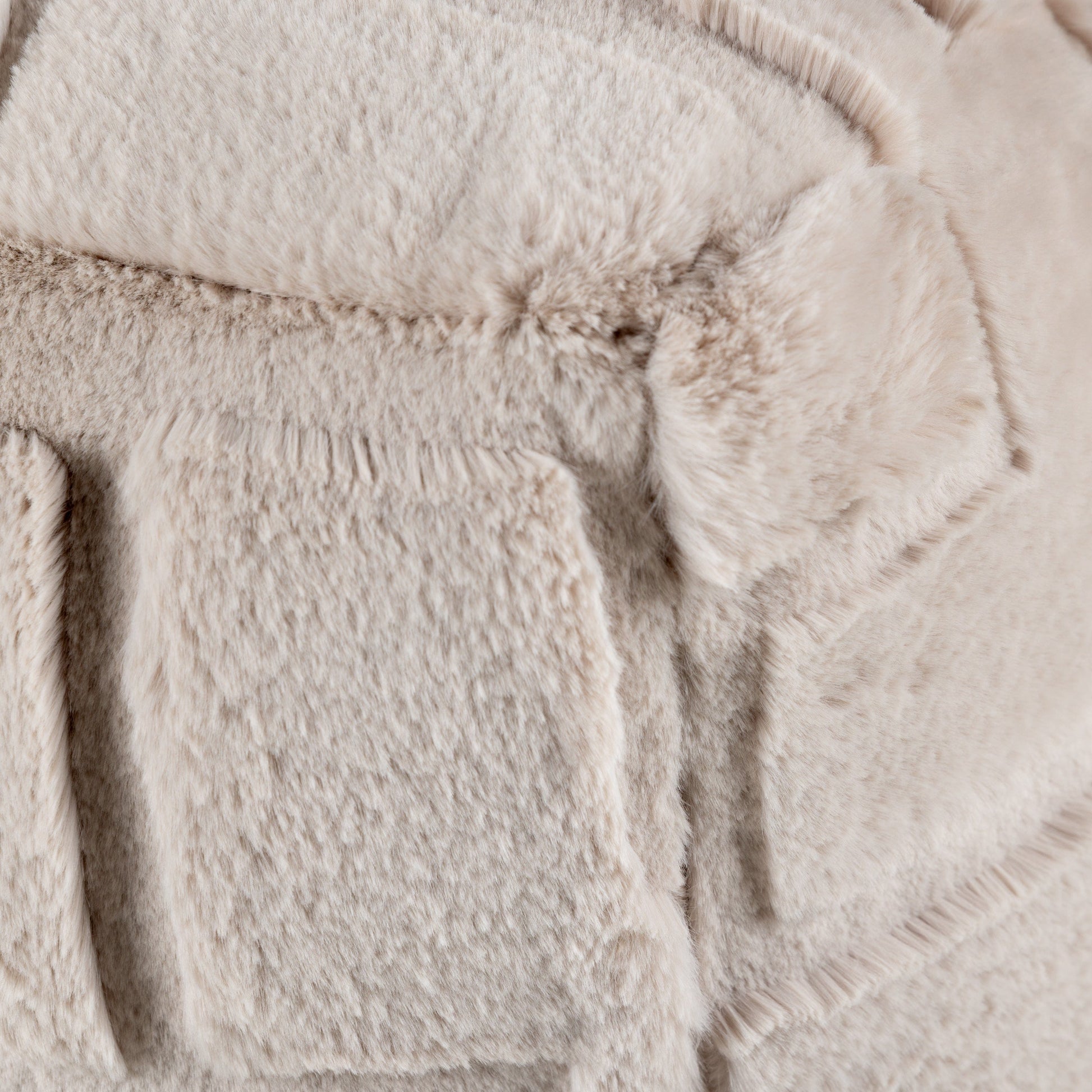 Close-up of a textured beige fabric surface on the cushion seat