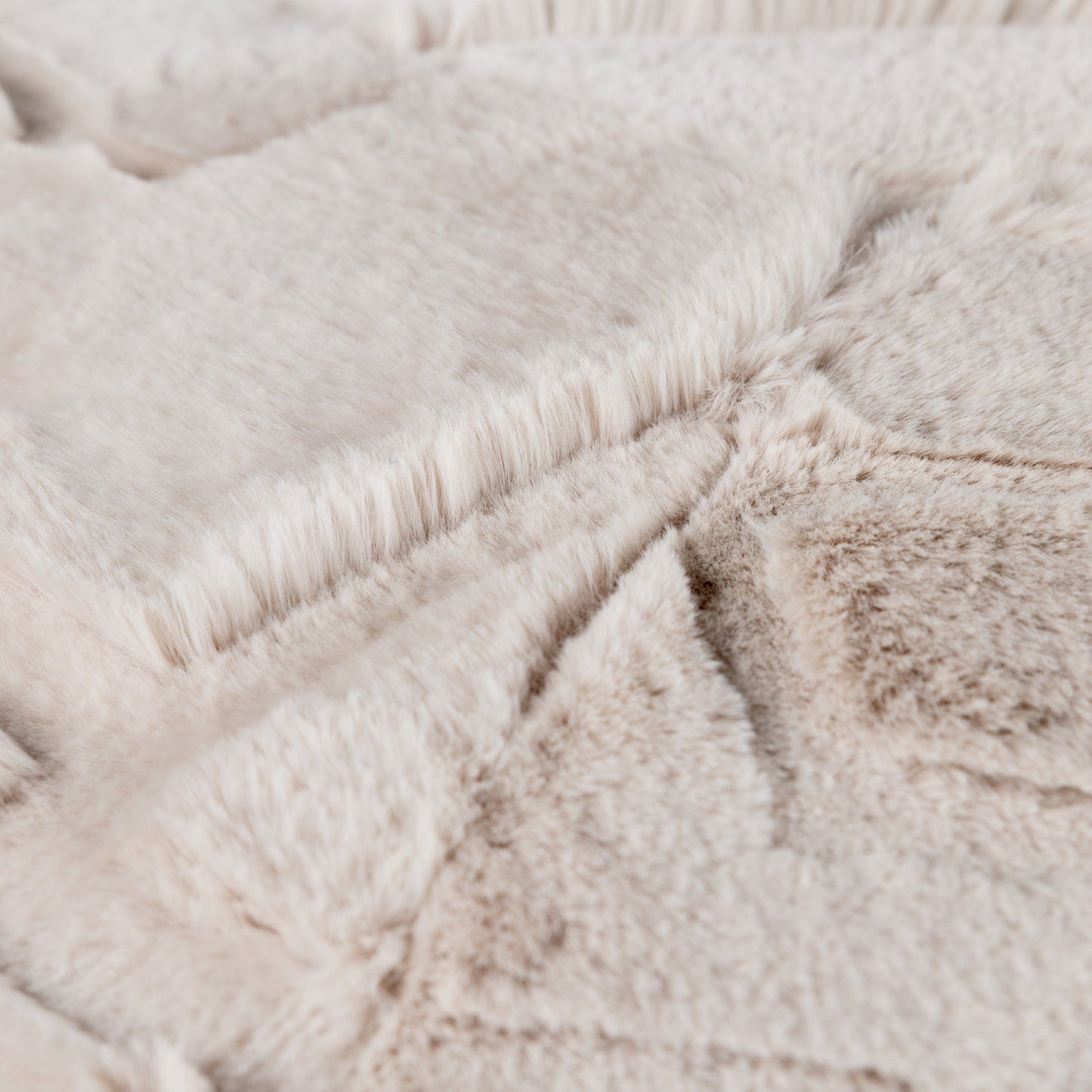 Close-up of a textured beige fabric surface of the Toni cushion pod seat