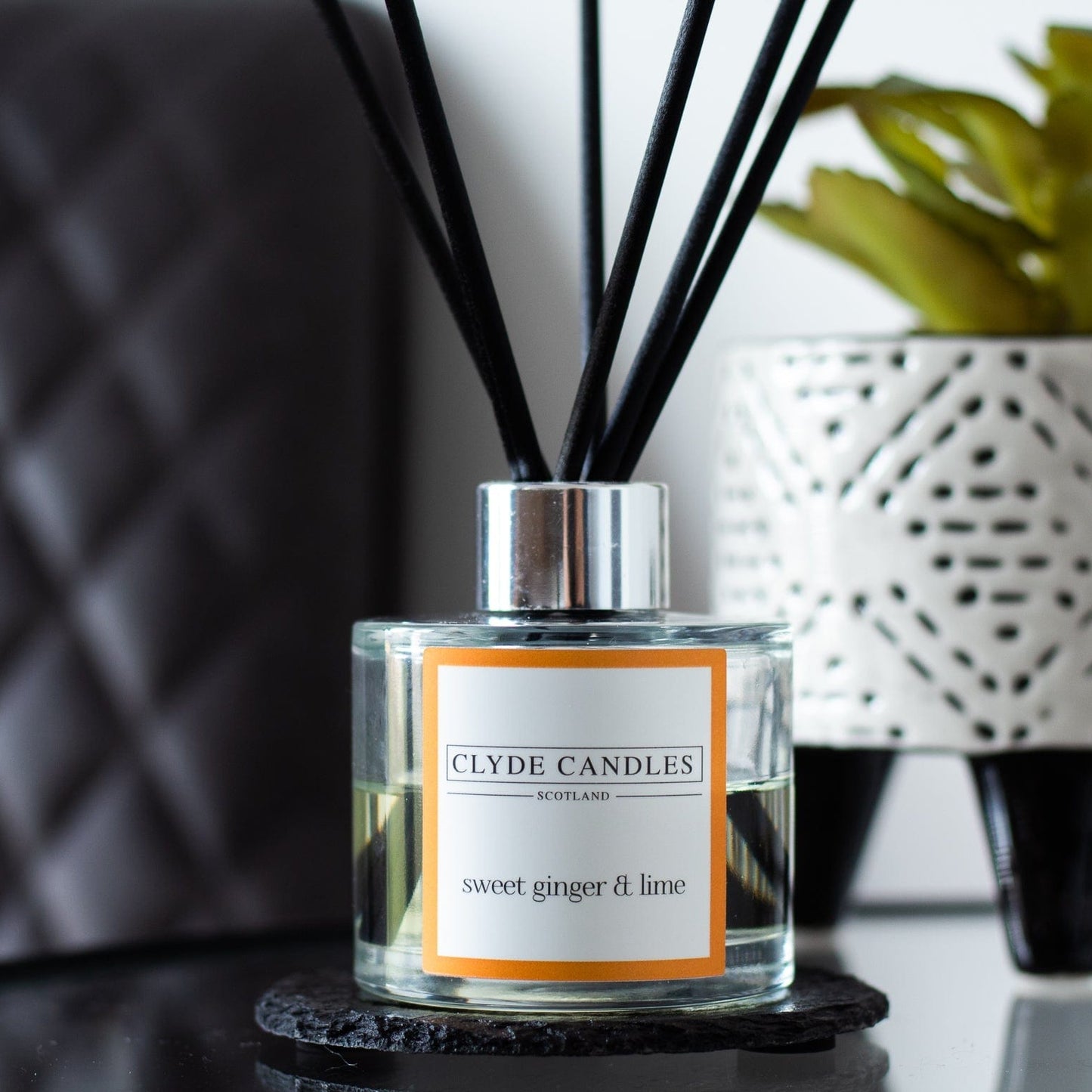 Clyde Candles sweet ginger & lime diffuser on a surface with a blurred background