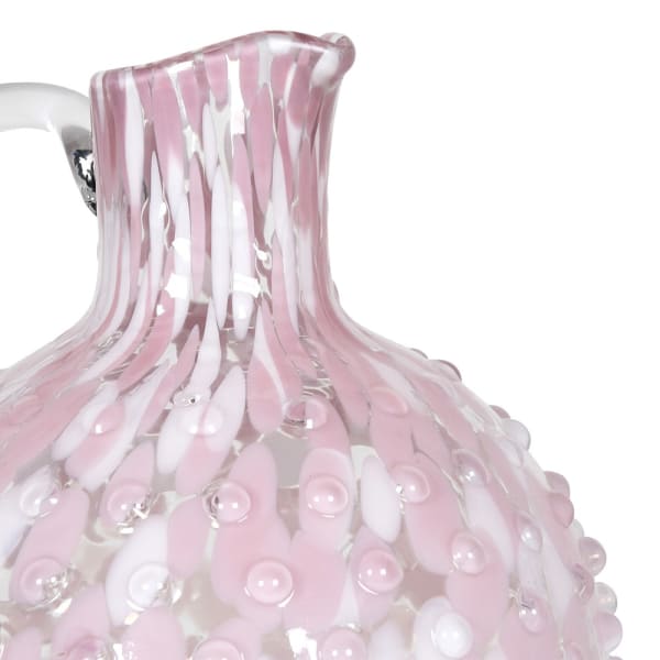 Close up of a pink and white marbled glass jug with a bubble effect.