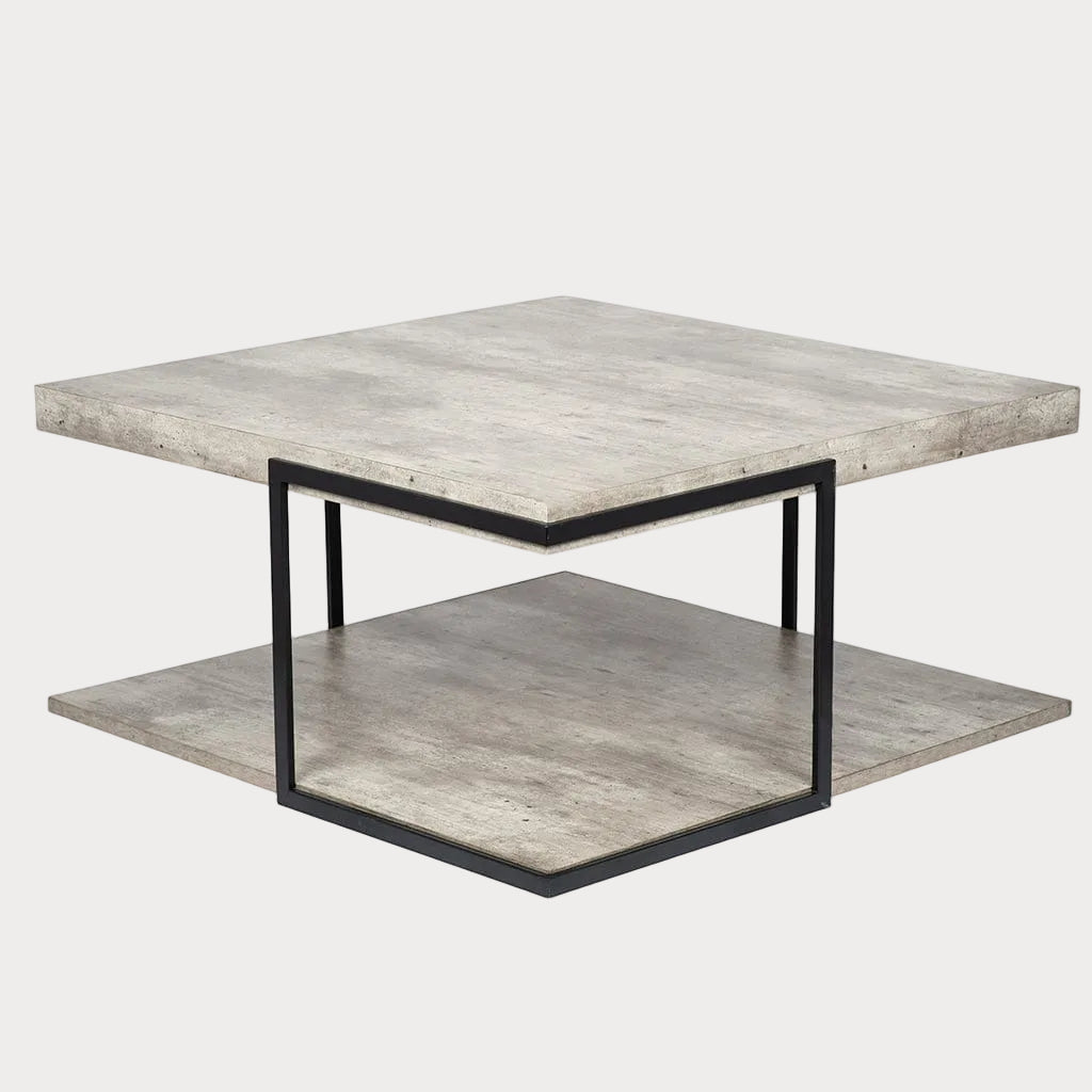 A square coffee table with a concrete effect surface and black iron frame, including a lower shelf with the same design.
