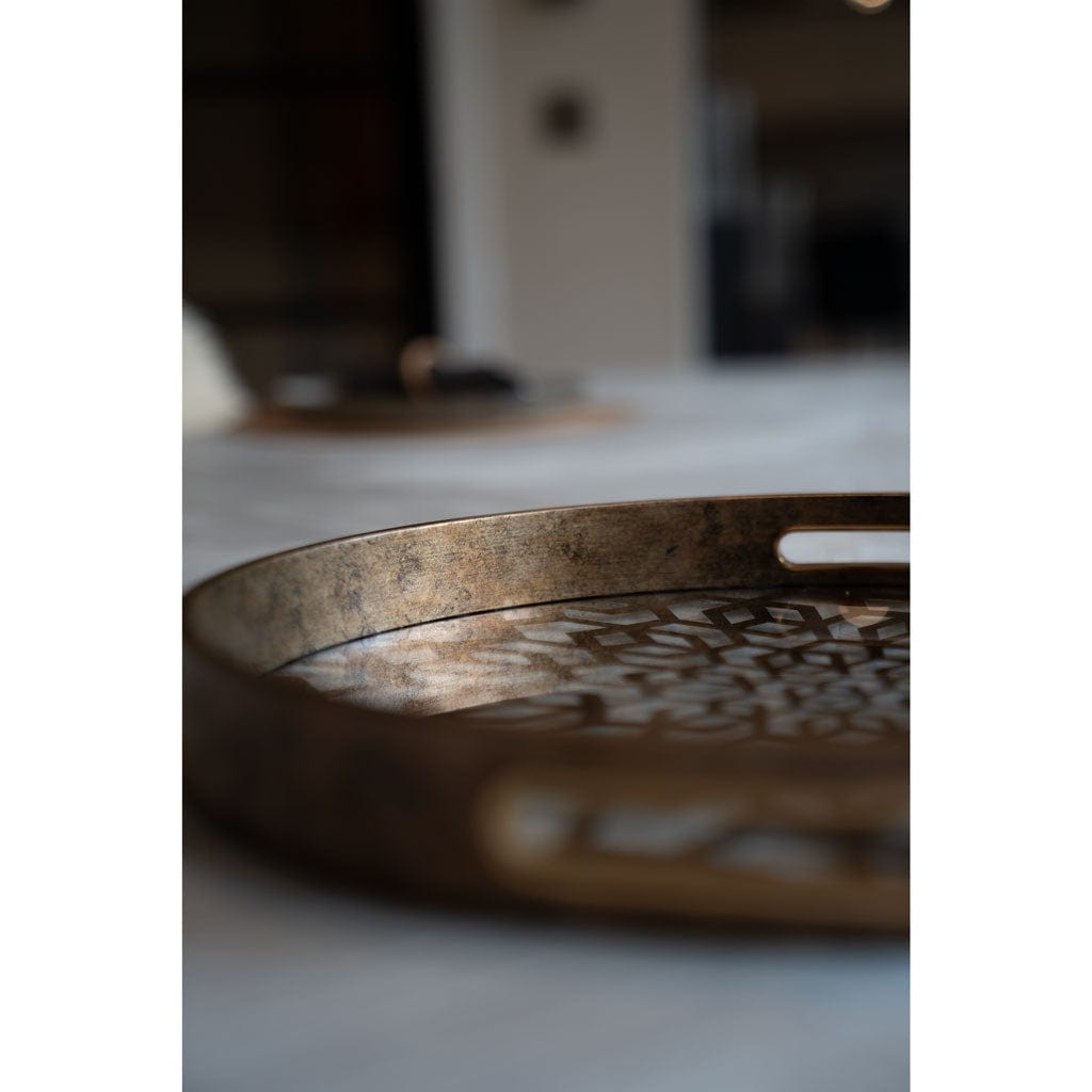 Decorative metal tray on a marble surface.