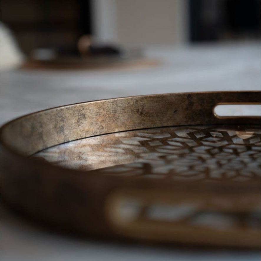 Decorative metal tray on a marble surface.