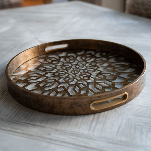 Bronze decorative tray on a marble surface