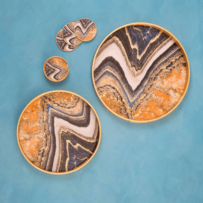 Set of decorative plates with marbled design on a blue background