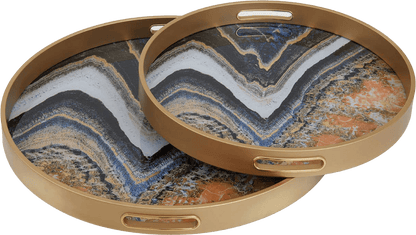 Two round marble-patterned trays with gold rims on a white background