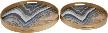 Two round marble-patterned trays with gold metal frames on a white background