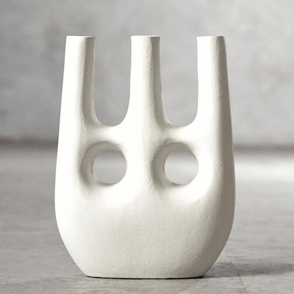 White abstract vase with two circular holes on a gray background