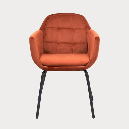 Orange velvet armchair with black legs on a white background