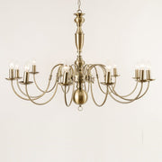 Antwerp 12 Light Antique Brass Flemish Style Chandelier with a ornate metal frame and multiple arms for candle-like lights, against a white background.