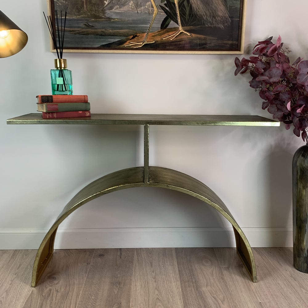 Decorative console table with books, a vase, and a painting in a room.