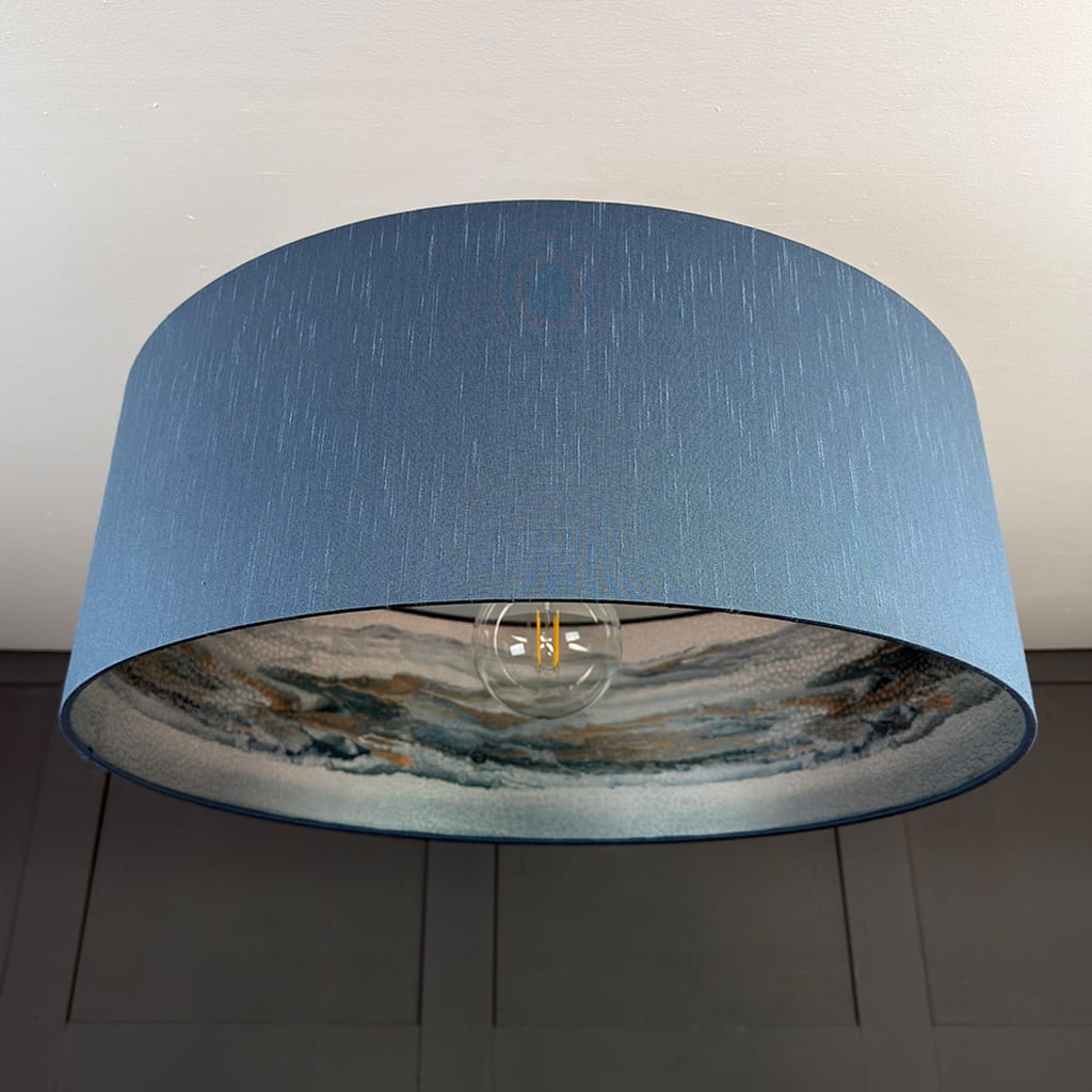 Blue lampshade with a textured design on a neutral background