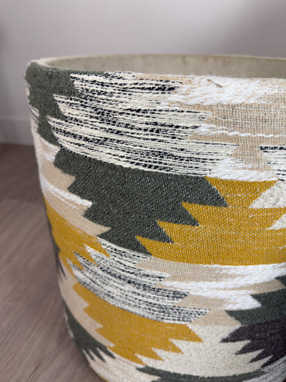 Close-up of a fabric-wrapped footstool object with geometric pattern