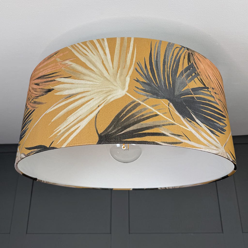 Lampshade with tropical leaf pattern on a plain background