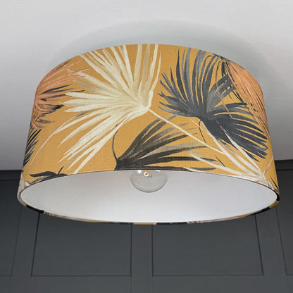 Lampshade with tropical leaf pattern on a plain background