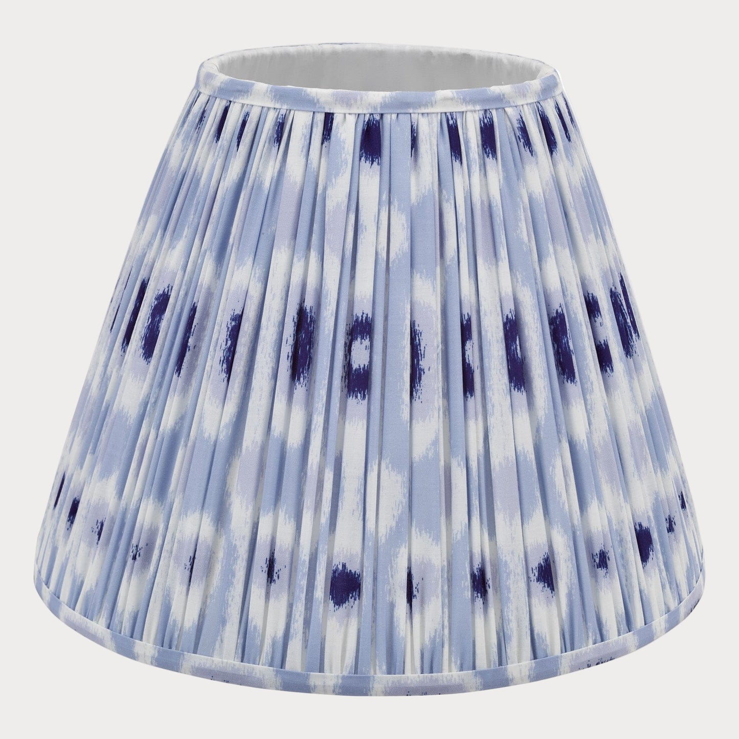 A blue and white ikat patterned cotton tapered drum shade for lamp post.