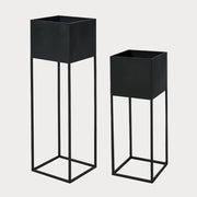 Two black graphite metal planters of different sizes, designed for indoor planting.