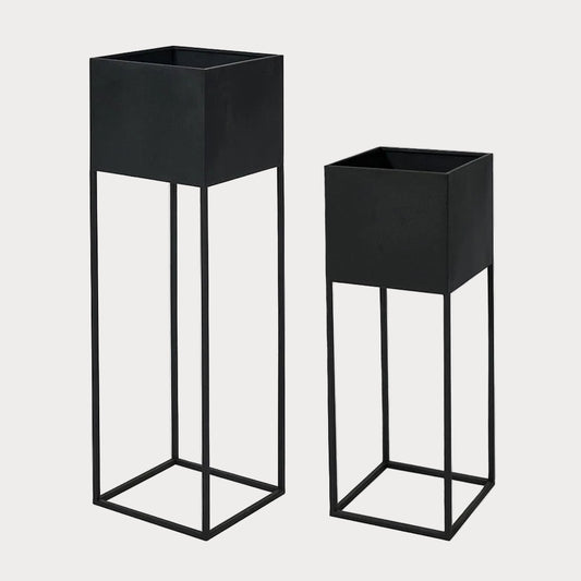 Two black graphite metal planters of different sizes, designed for indoor planting.
