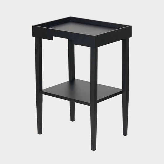 A black rectangular Marnie side table with a wood veneer finish, featuring a cut-out design and a lipped top, with one shelf beneath the tabletop.