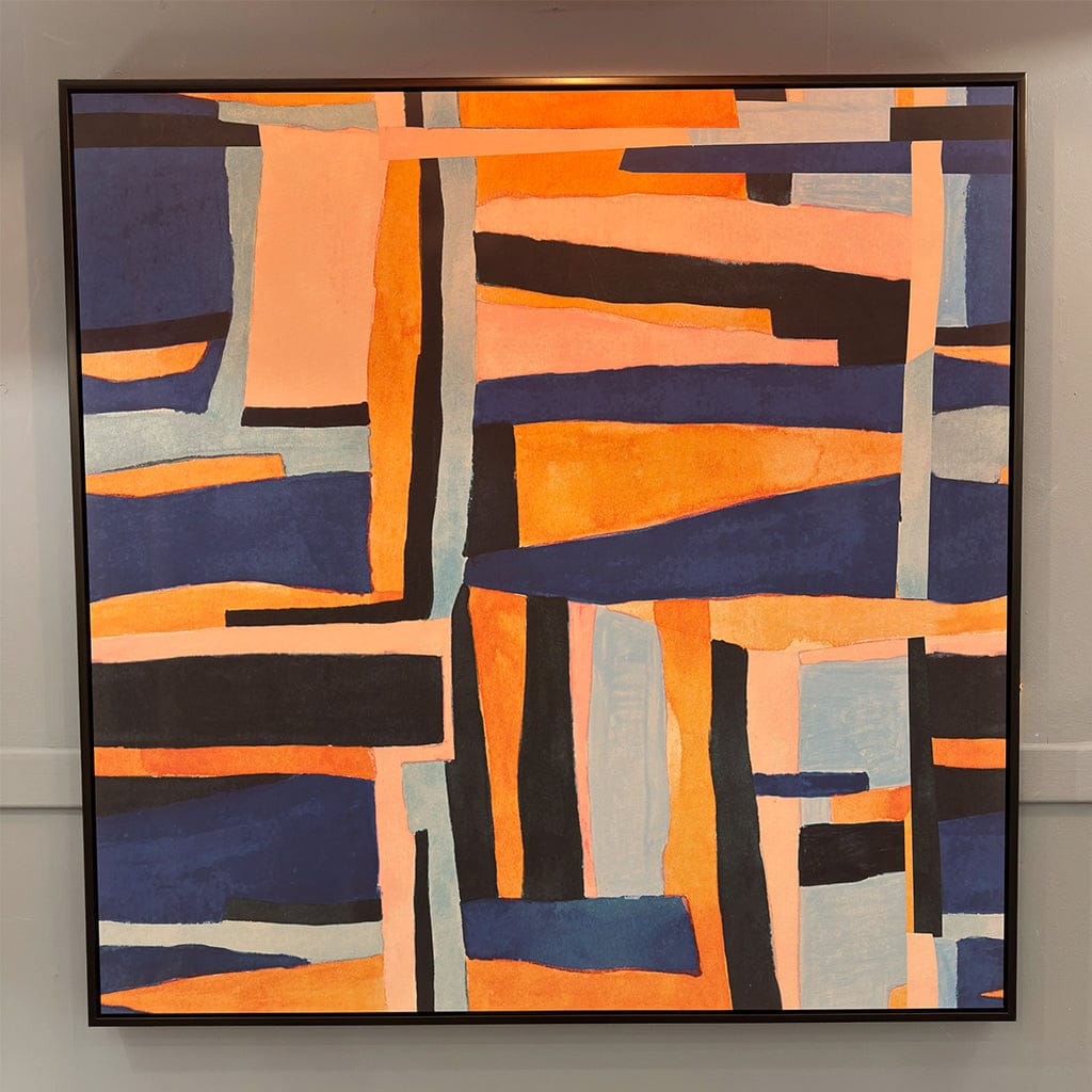Abstract art piece with geometric shapes in orange, blue, and black on a gray wall.
