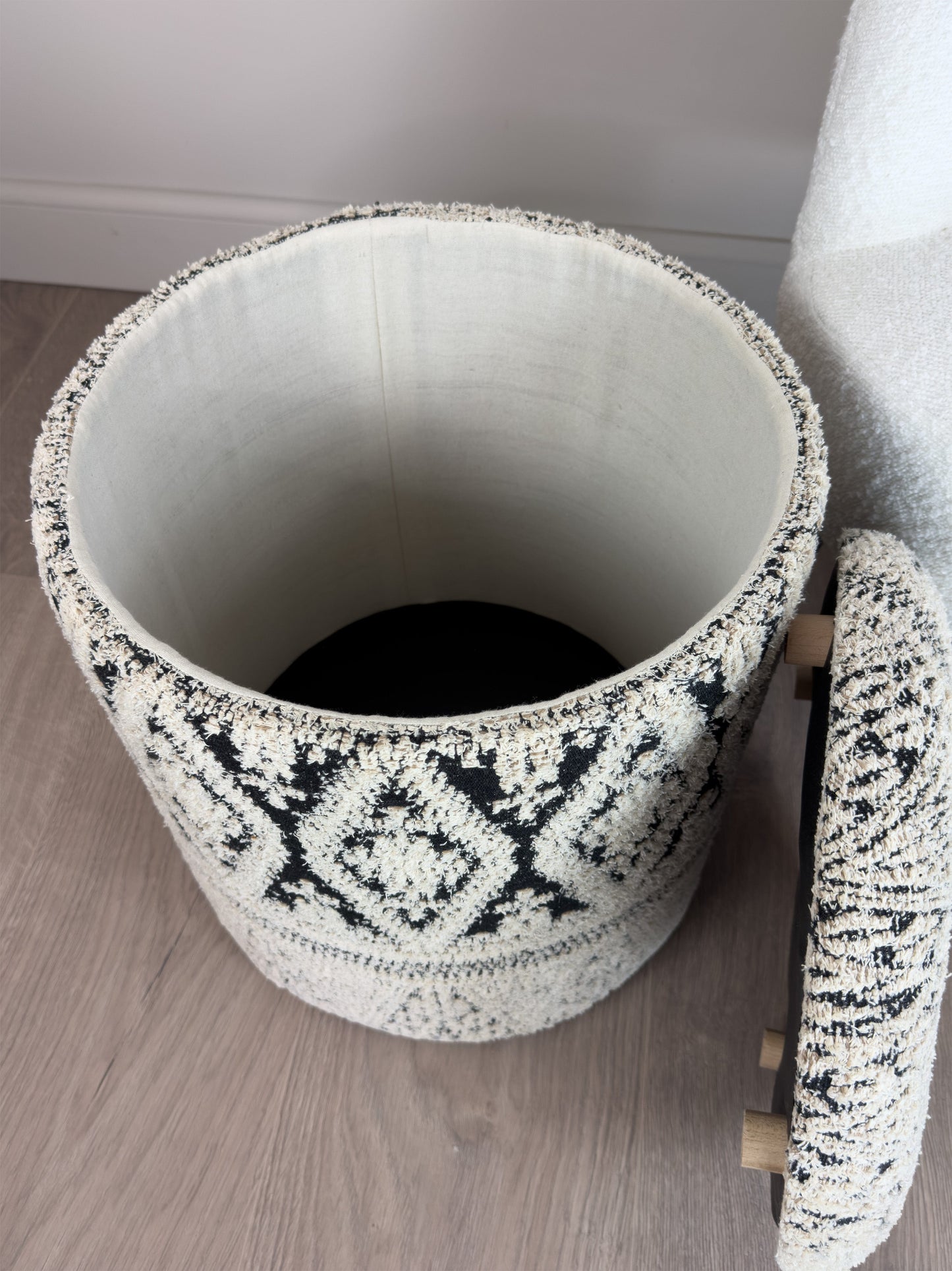 Textured storage basket with geometric pattern on a wooden floor