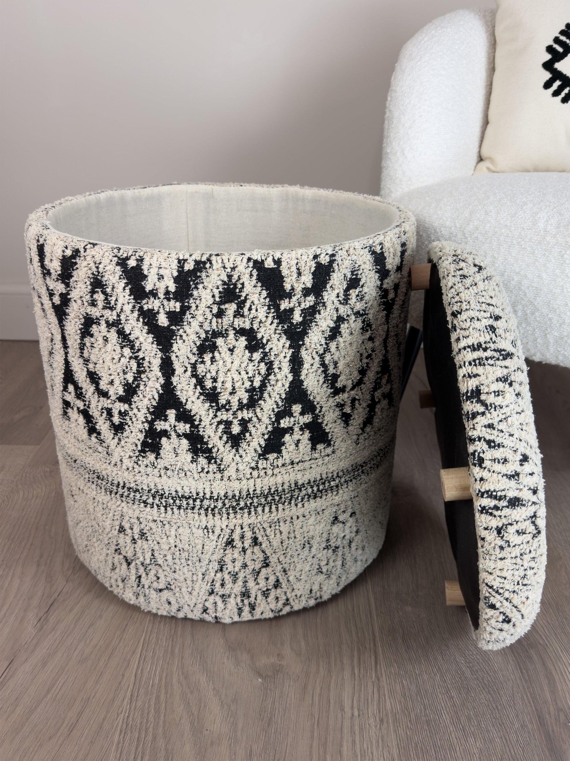 Tufted storage ottoman with geometric pattern on a wooden floor