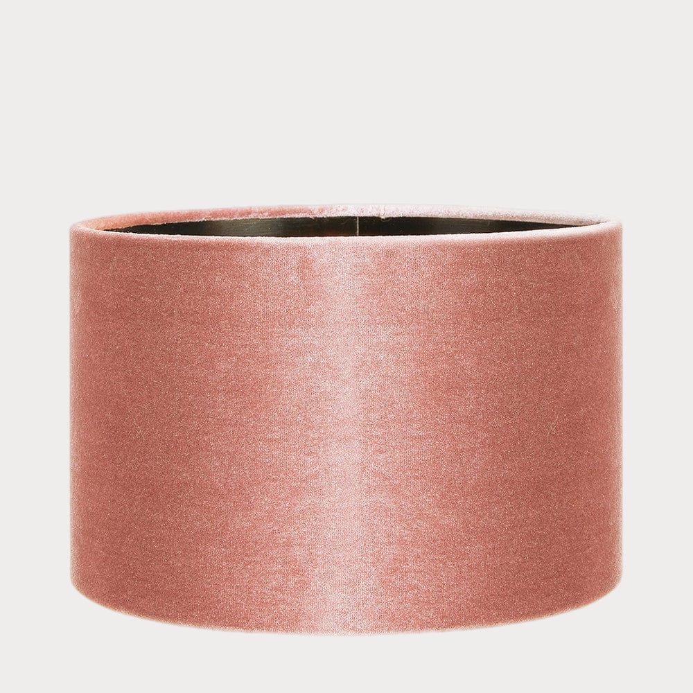 A cylindrical velvet lampshade in apricot color with a bronze lining, displayed against a plain background.