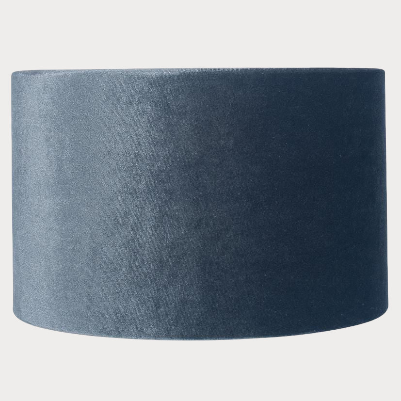 A cylindrical velvet lampshade in slate grey color with a bronze lining, displayed against a plain background.